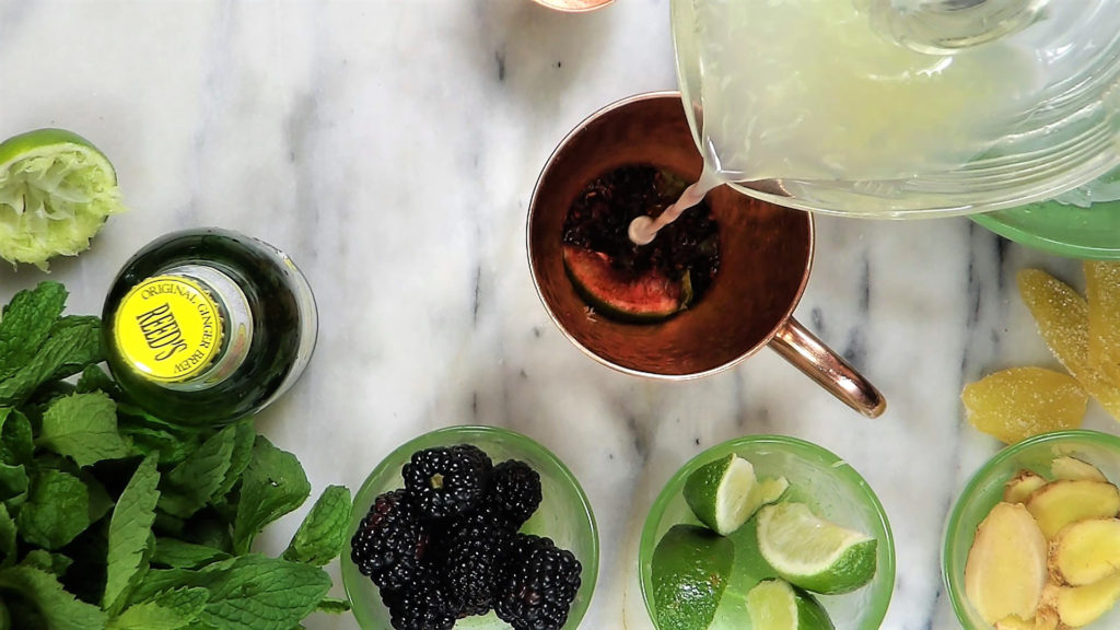 Add fresh squeezed lime juice over muddled berries and mint