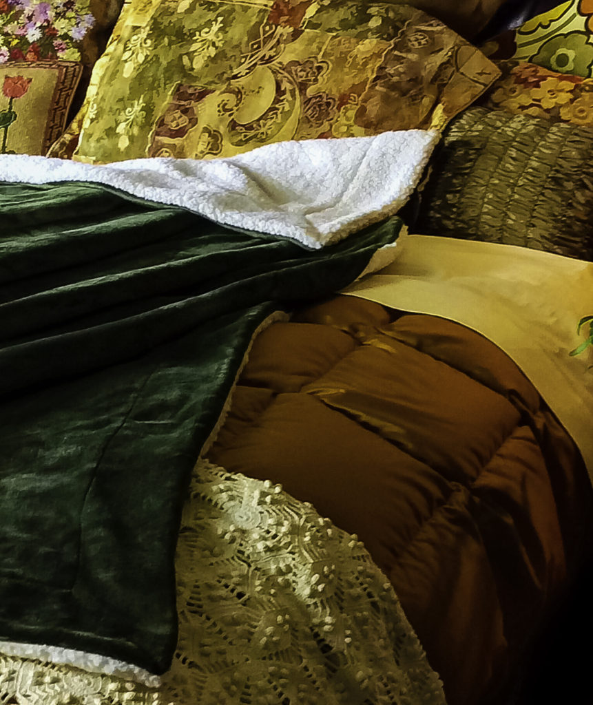 Close up of Olive Green Bedsure blanket with other bedding 