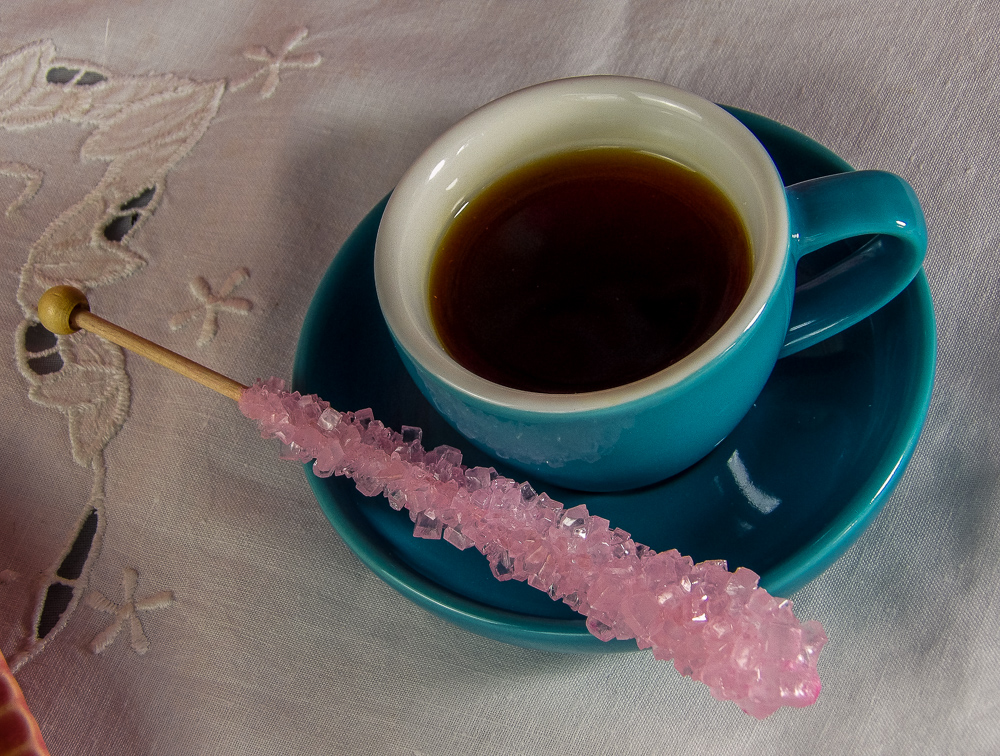 With a rock candy swizzle stick to sweeten the drink to taste.