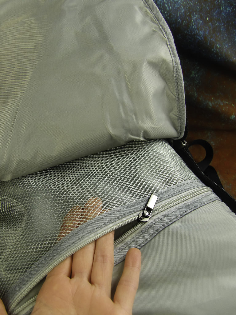 The front compartment can hold a tablet plus has a zippered mesh pocket for holding devices and wares