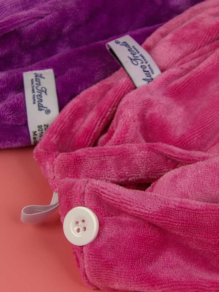Button and loop hold the towel comfortably and securely in place