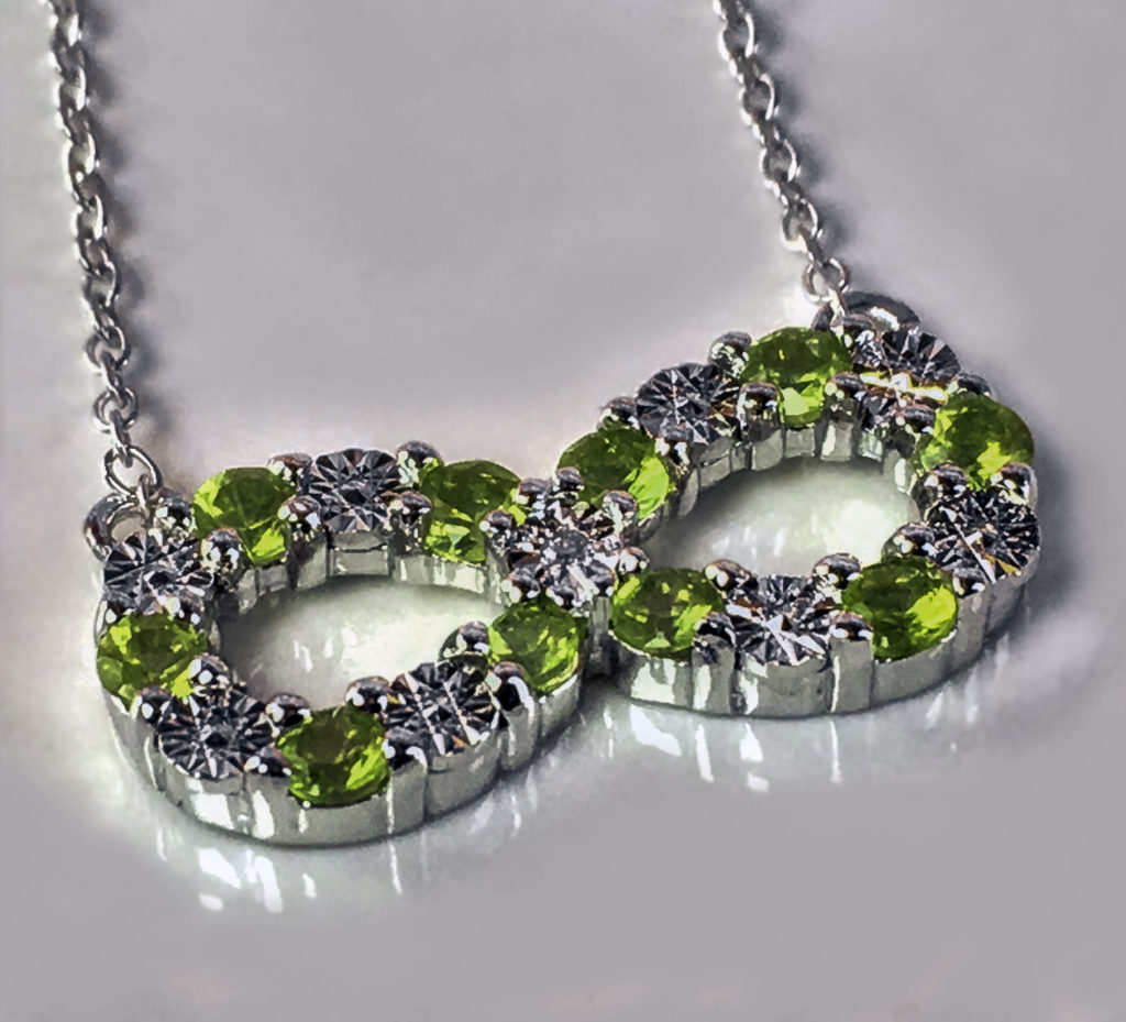 The combination of round cut Peridot gemstones, Sterling Silver and diamond has a lovely sparkle!