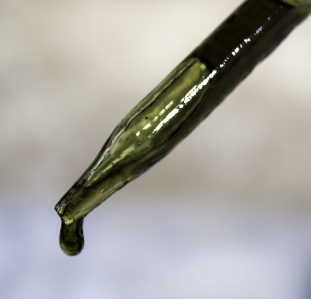 A golden green drop of Prime Natural Organic Tamanu Oil. 