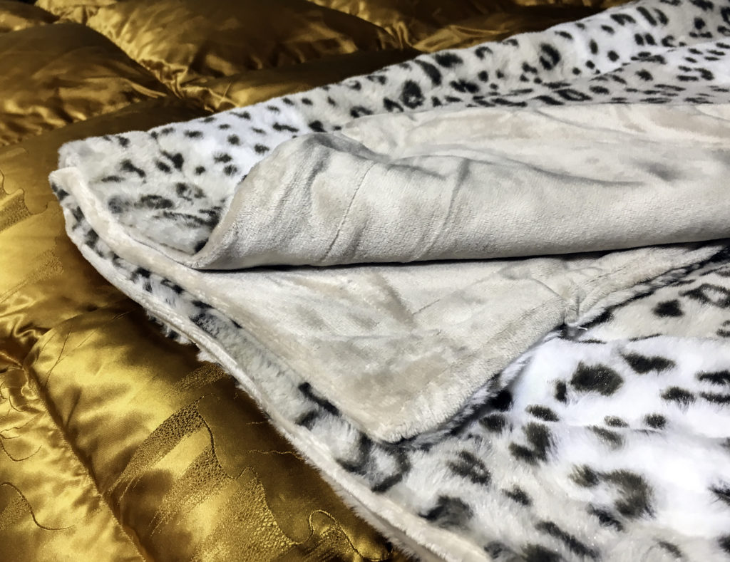 Two sided throw blanket with faux fur on one side and silky smooth microfiber on the reverse