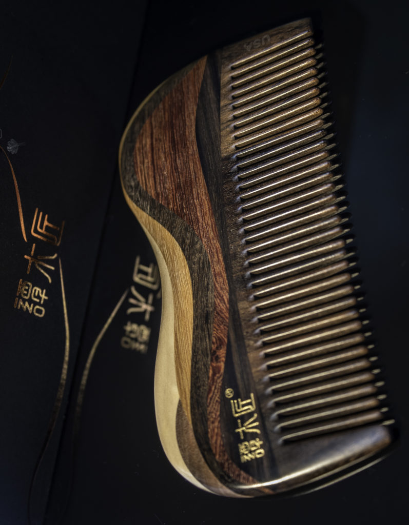 A wood comb helps distribute the oil without snagging hair